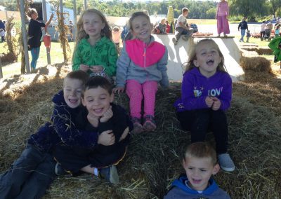 Children sitting on hay