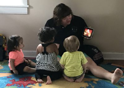 Children watching video with teacher